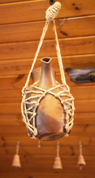 istock A ceramic jug with a spout suspended on a rope. Ceramic and clay dishes. Decor 1464099684