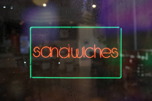 istock Neon Sandwiches sign on a wet window 1464100743