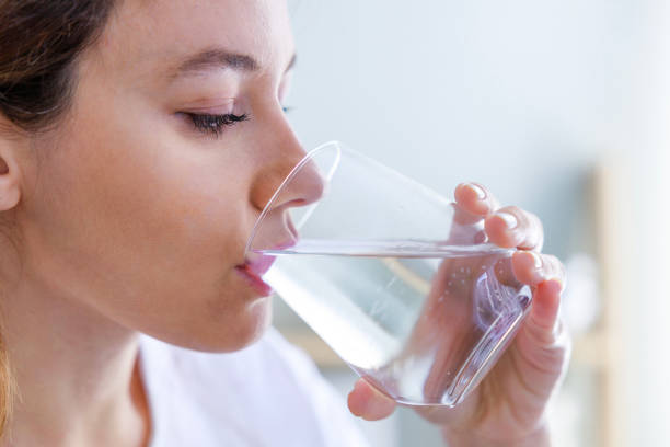 istock Woman drinking water at home 1464102053