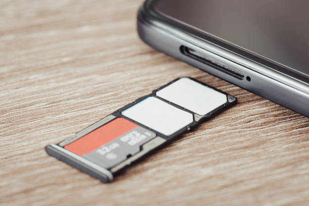 istock Close up of phone tray with two sim cards and a memory micro sd card 1464103657