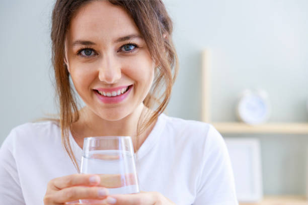 istock Woman drinking water at home 1464103805