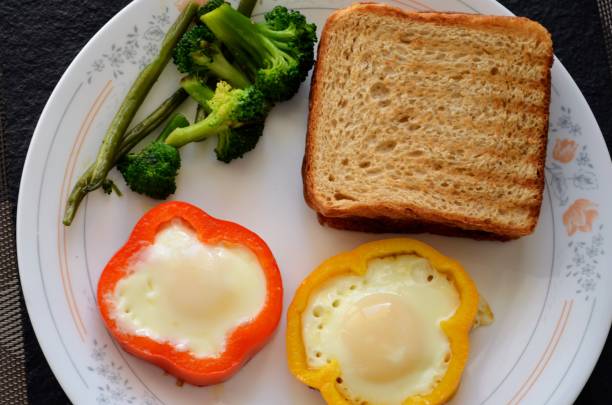 istock Four fried eggs in a pan cooked in yellow and red coloured bell pepper rings. India breakfast. Tasty, juicy nutritious and fresh. Pretty presentation. Tempting. 1464103874