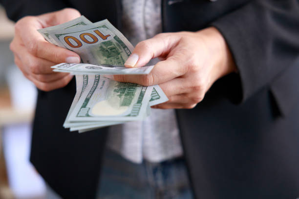 istock Young female hands count dollar bills 1464104147