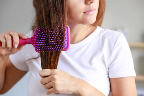 istock Young woman brushing her hair 1464104296