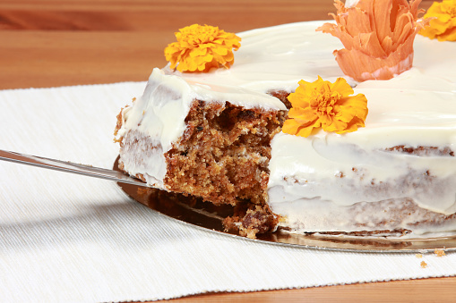 Banana cake with icing sugar and decorative flowers