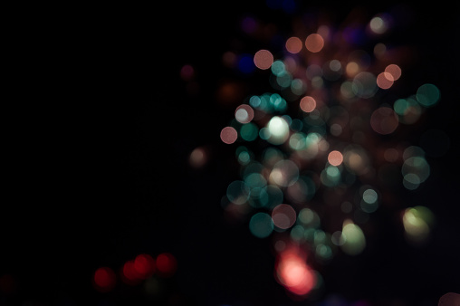 Blurry photo of firework. Salute without focus. A beautiful flicker of white bokeh.
