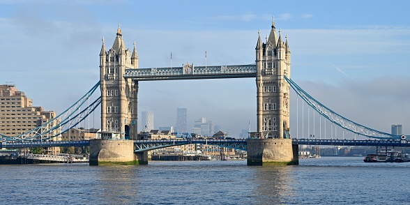 The Tower Bridge over the River Thames against a cloudy blue sky, London, the United Kingdom