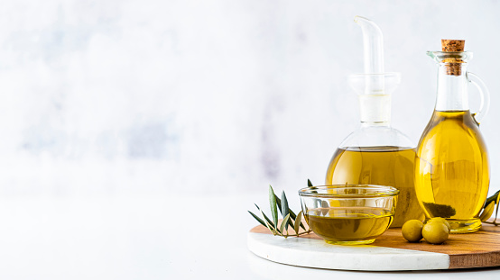 Group of three olive oil bottles with copy space on a kitchen countertop