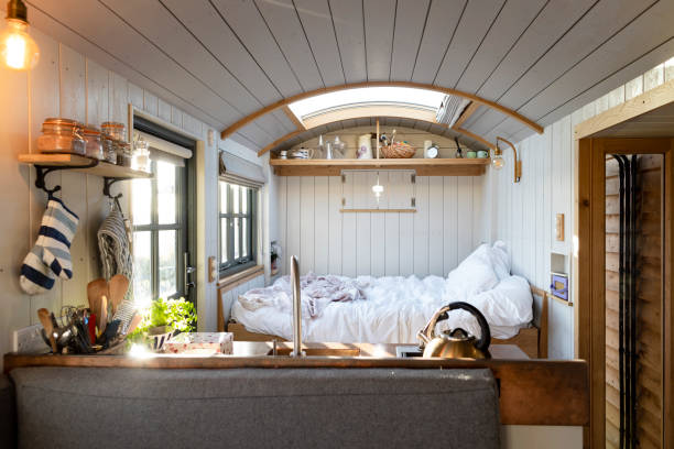 Cabin vacation lodge in Alnwick, North East England. There is a double bed and small kitchen in the space. The room has lots of natural light.