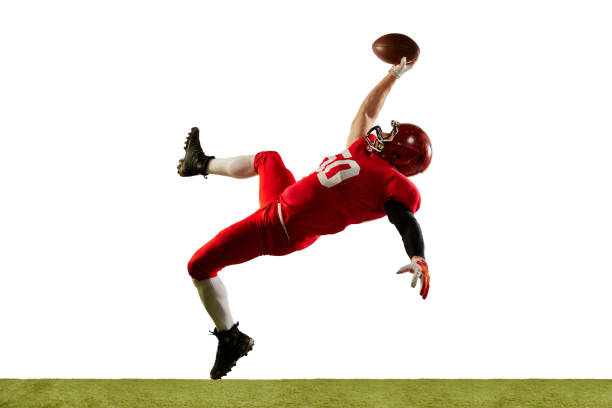 Professional american football player in sports uniform and protective helmet in action isolated over white background. Sport, team, competition, bowl Professional american football player in sports uniform and protective helmet in action isolated over white background. Concept of active life, team game, energy, sport, competition. Copy space for ad american football player studio stock pictures, royalty-free photos & images