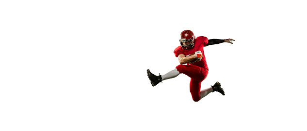 In motion. Dynamic portrait of american football player in sports uniform and protective helmet training with ball isolated over white background. Sport, team, competition, championship. Flyer for ad