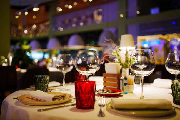 istock a table with a white tablecloth, glasses, crockery and decor in dark restaurant 1464113874