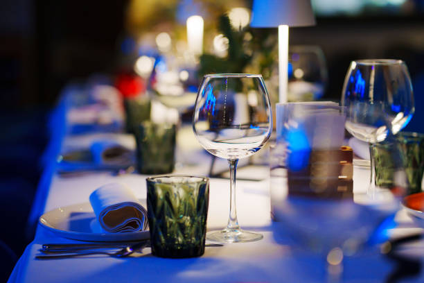 istock a table with a white tablecloth, glasses, crockery and decor in dark restaurant 1464115781