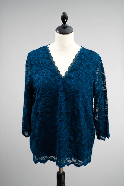 istock Dark blue top with lace hanging on a headless mannequin. isolated by a light gray or white background. 1464116038
