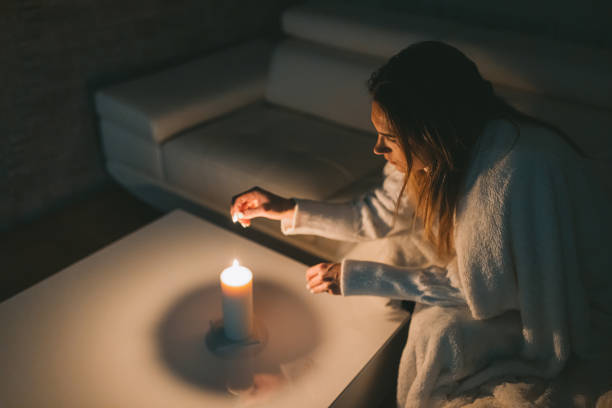 istock Woman lighting up the candle 1464116199