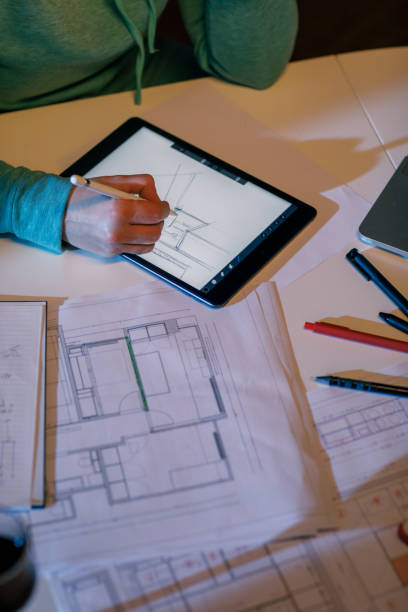 istock Female Interior Designer Working On Digital Tablet 1464116648