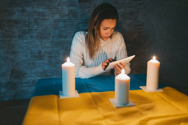 istock Scared woman searches for a solution on a tablet during a power outage 1464117815