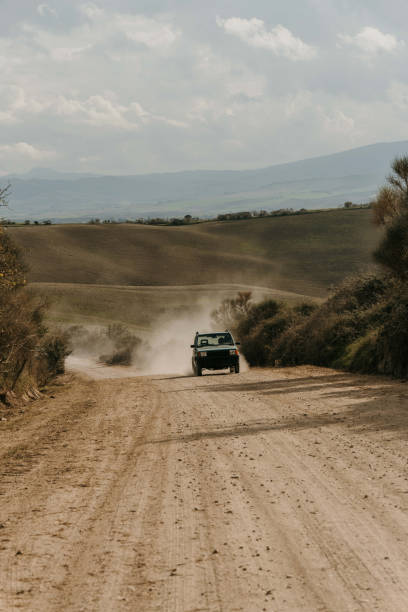 istock Car on dirt road in Tuscany 1464120476