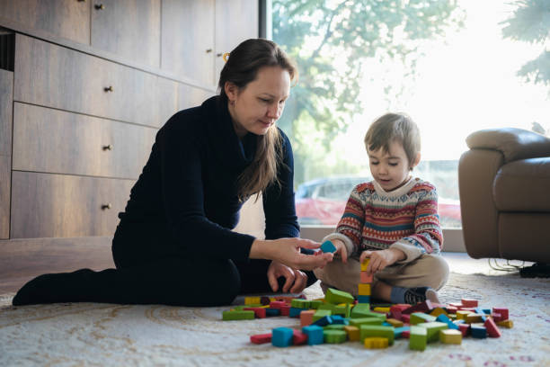 istock Mother And Son Playing With Toy Blocks At Home 1464120596