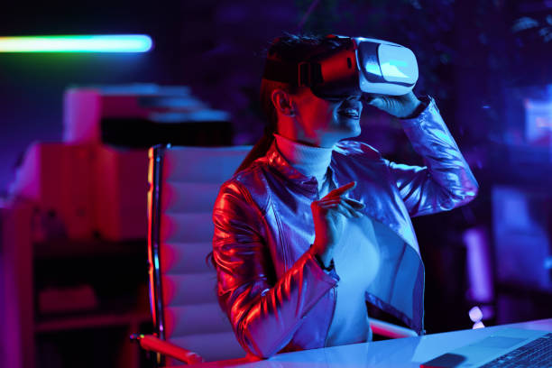 istock smiling stylish female in vr headset in modern office 1464121147