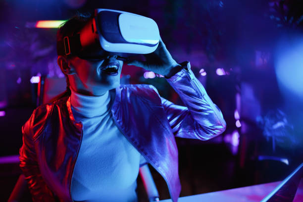 istock smiling trendy female testing out virtual reality in office 1464121189