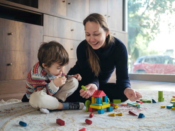 istock Mother And Son Playing With Toy Blocks At Home 1464121821