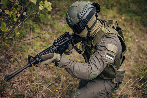 Expert team of soldiers attacking enemy during military operation, Army soldiers in protective combat uniform, Soldiers with rifle on world war field