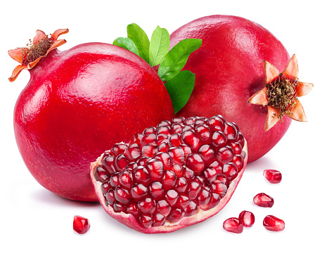 Whole pomegranate fruit with leaf and a piece with ripe red pomegranate seeds isolated on white background.