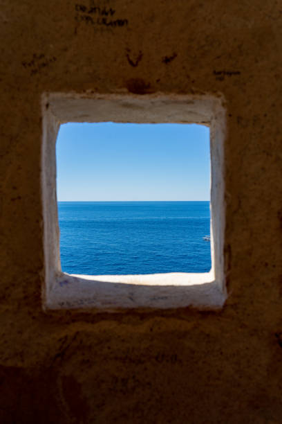 istock Blue sea seen through a square hole 1464125304