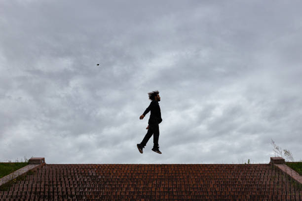 Trapeze artist flying in the blue sky