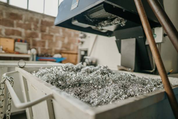 Scrap aluminum dust and metal trash fall of machinery in workshop.