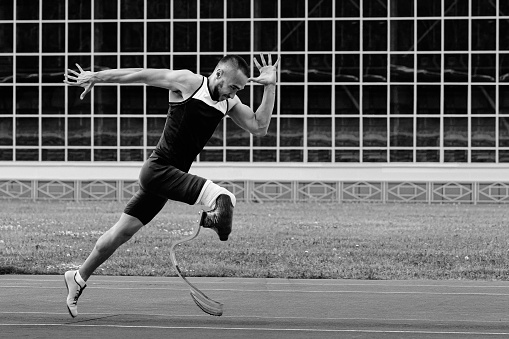 Sports, workout and male tennis player playing match at an outdoor court stadium for training or exercise. Fitness, badminton and man athlete practicing for game, championship or tournament at arena.