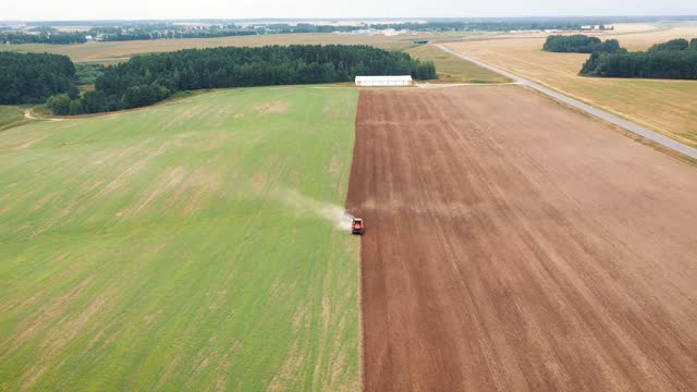 Farmer On Tractor Plows Fertile Agricultural Land With Plow Aerial View