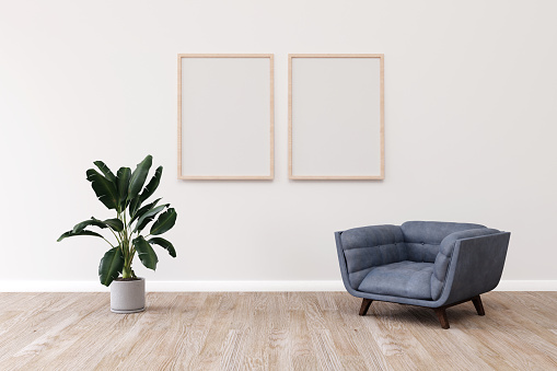 Modern room design with a comfortable armchair and two frames on the wall. 3d illustration