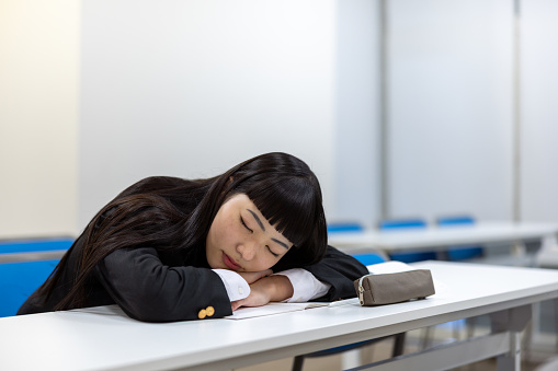 High school girl studying in classroom - napping