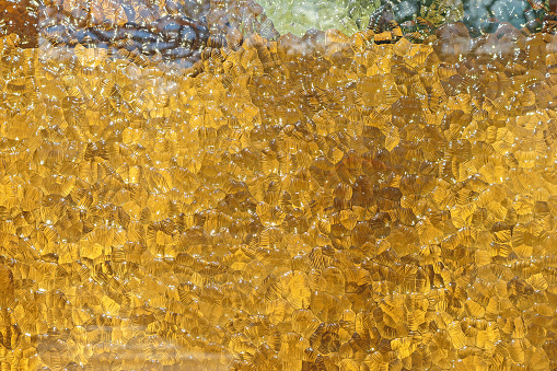 Yellow glass abstract background close-up