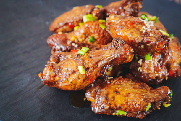 istock fried chicken with garlic and sesame in caramel on a black tray. 1464135902