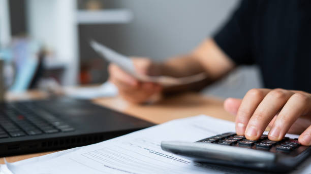 istock Close-up Man is calculating house bills cost 1464135977