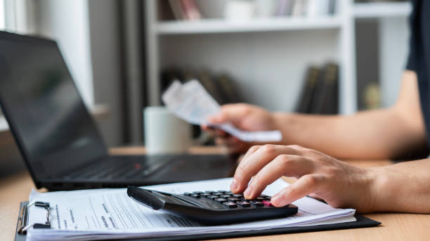 istock Close-up Man is calculating house bills cost 1464135982