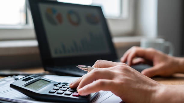 istock Close-up Man paying bills from laptop 1464136061