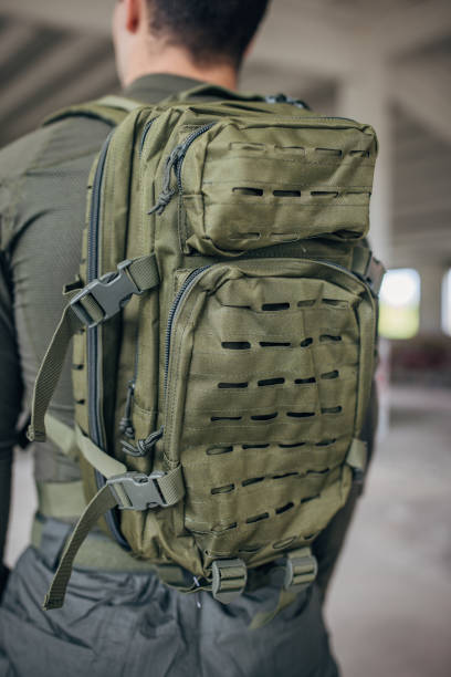 istock Young man putting military tactical equipment 1464138237