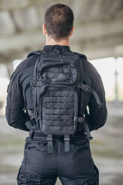 istock Young man putting military tactical equipment 1464138885