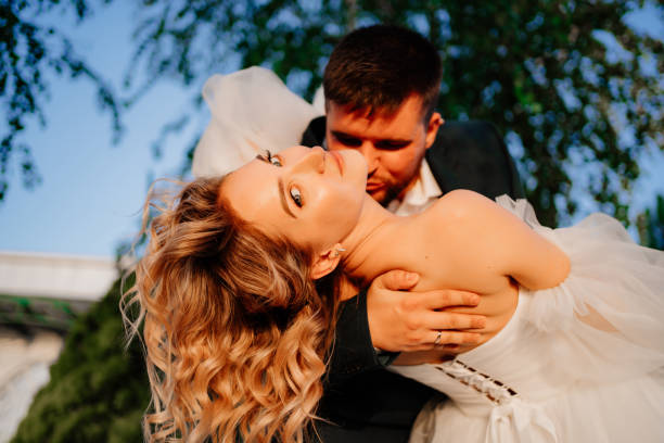 istock close up. dancing happy bride and groom in nature. 1464142997