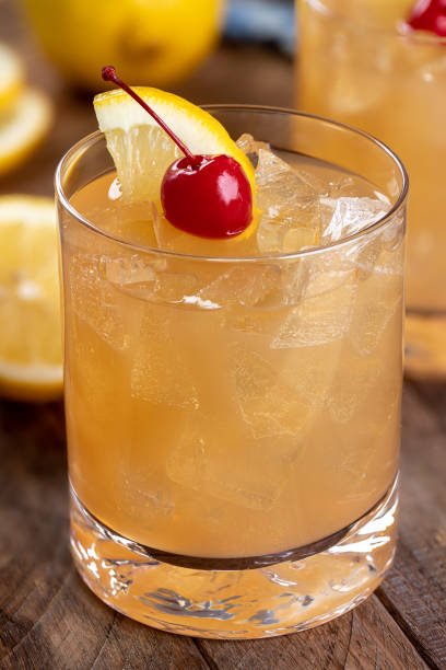 istock Whiskey sour cocktail with cherry and lemon 1464144475