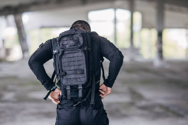 istock Young man putting military tactical equipment 1464145042