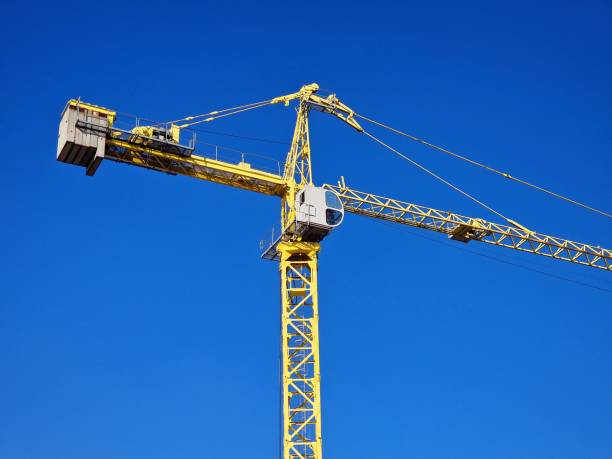 istock crane works on the construction of a house 1464145446