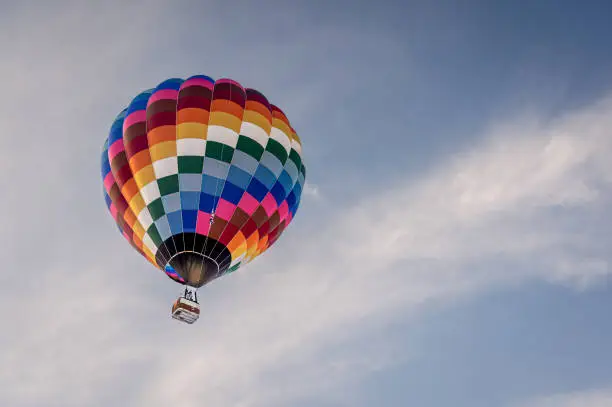 Photo of Hot Air Balloon in flight. Hot air ballooning flying in the sky in Switzerland.