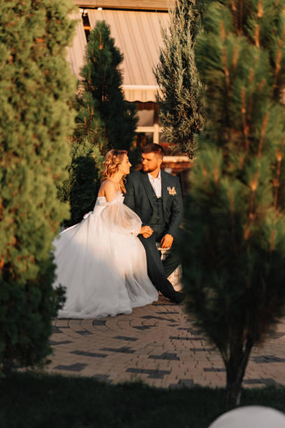 istock the bride and groom on a park bench. 1464145652