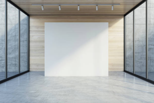 istock Front view on big blank white partition with space for your logo or advertising text on wooden background in empty presentation hall with transparent walls and concrete floor. 3D rendering, mockup 1464147235