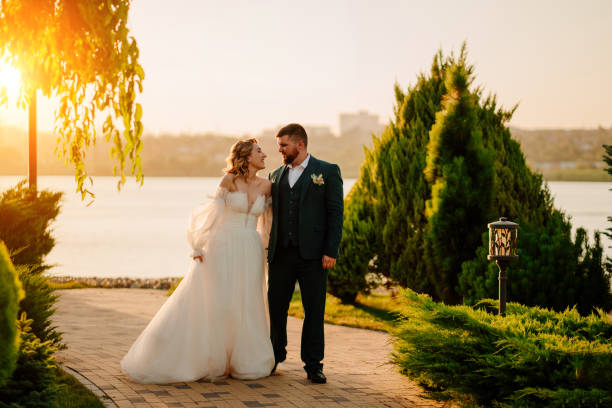 istock the bride and groom walk holding hands along the path 1464147904
